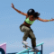 Imagem exibe uma jovem em uma manobra de skate